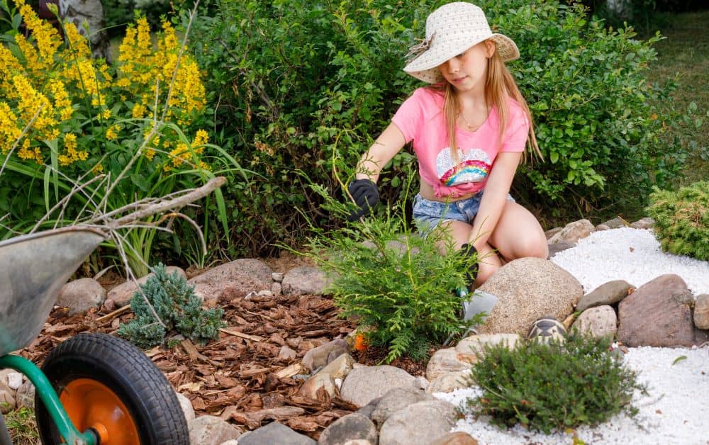 Girl creating rock garden.